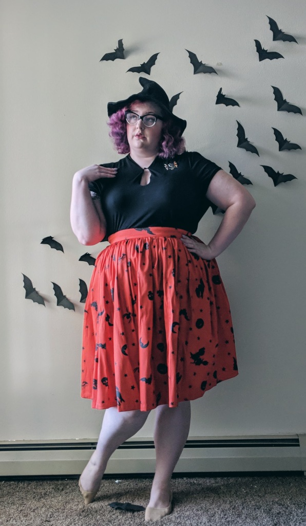 Woman wearing Halloween skirt and witch hat